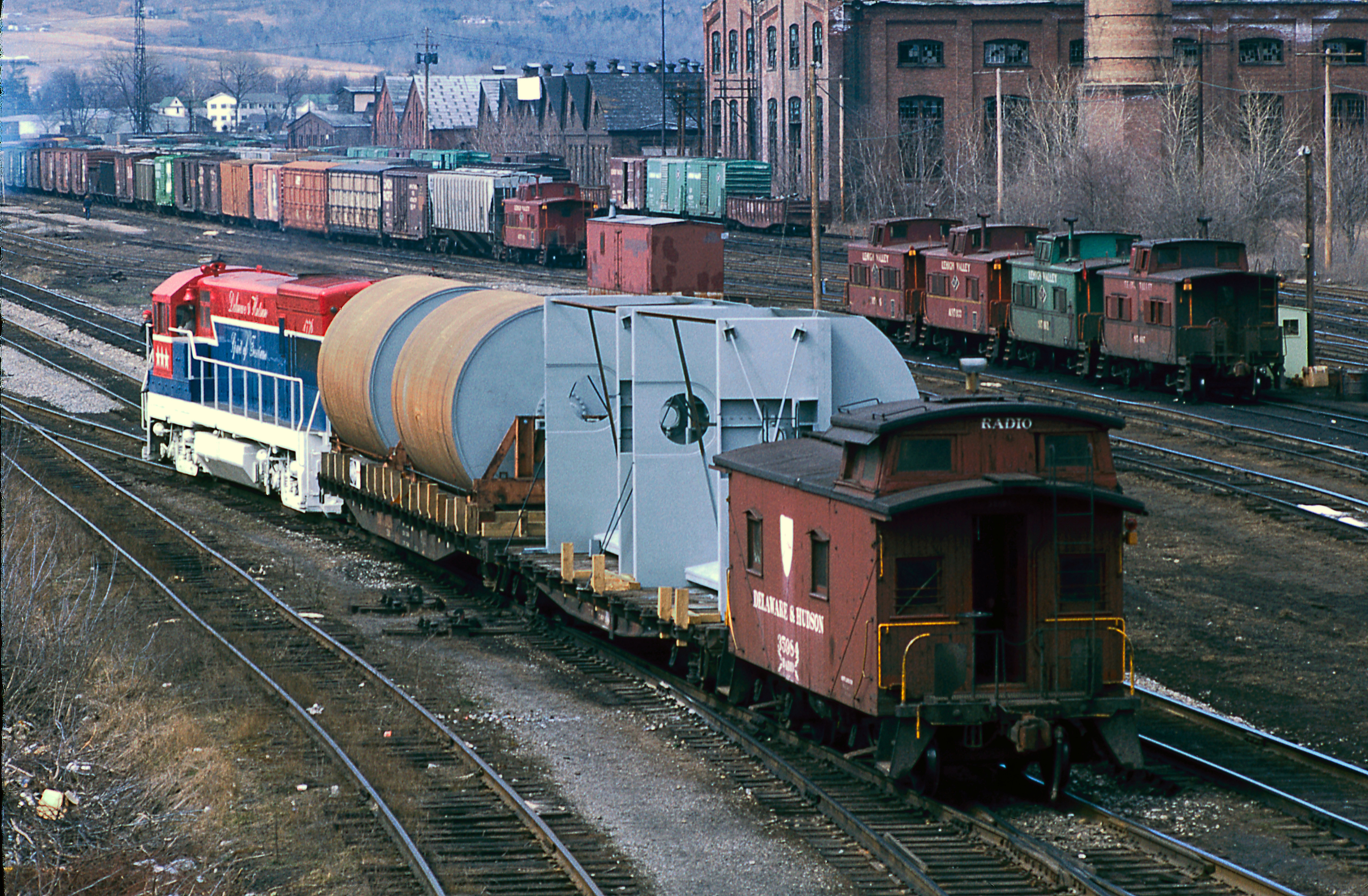  April 10, 1975 Going away view of D&H #OFX-1 with 1776 at LV yard in Sayre, Pa.